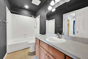 Full bath featuring vanity, light tile patterned flooring, and bathing tub / shower combination