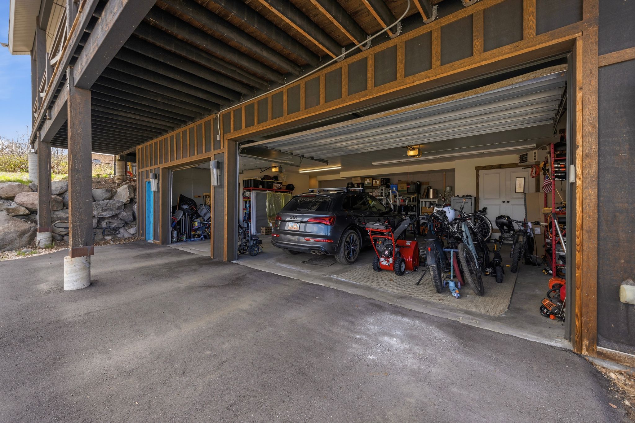 Garage with a heating unit and asphalt driveway