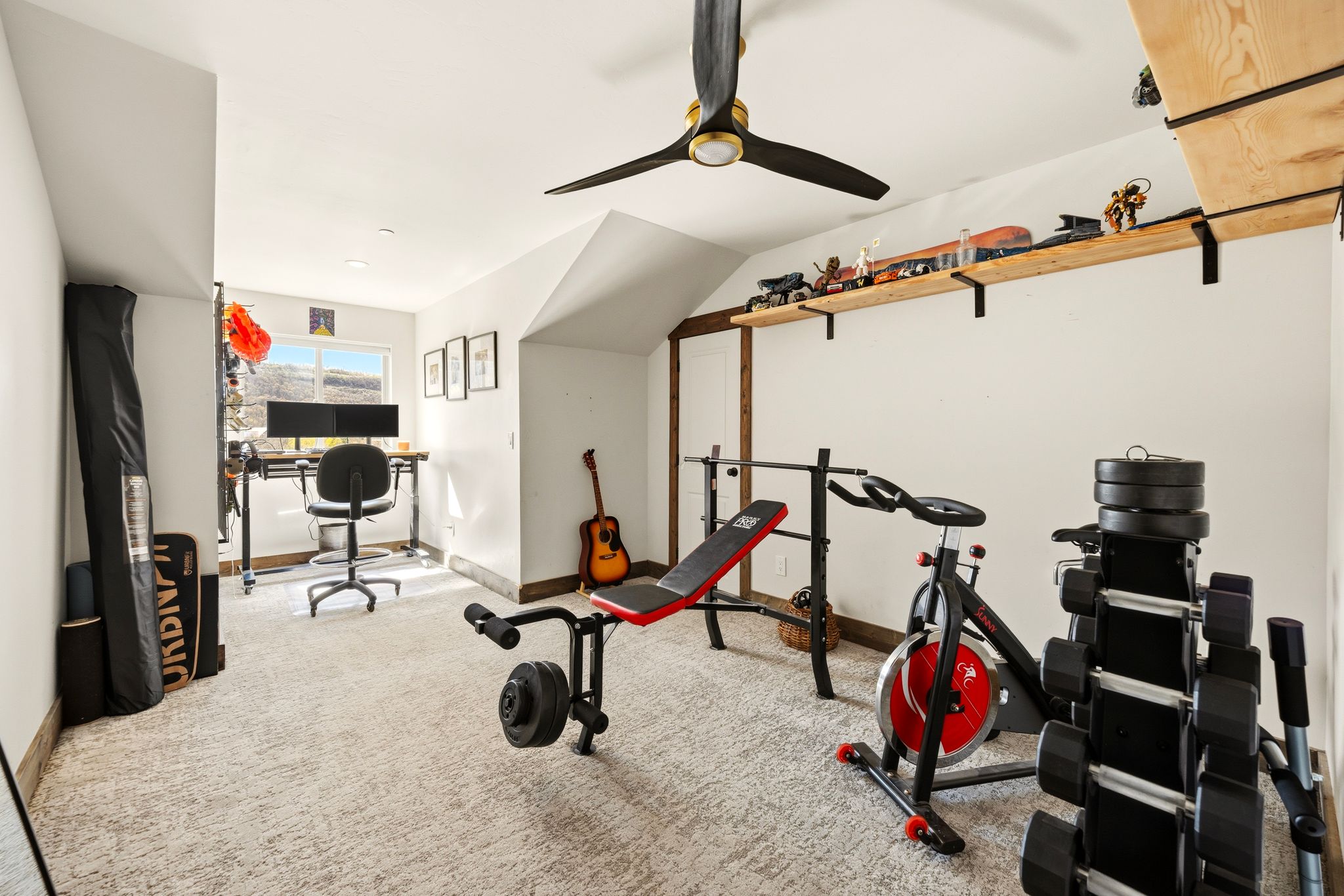 Exercise room with carpet flooring, lofted ceiling, and ceiling fan