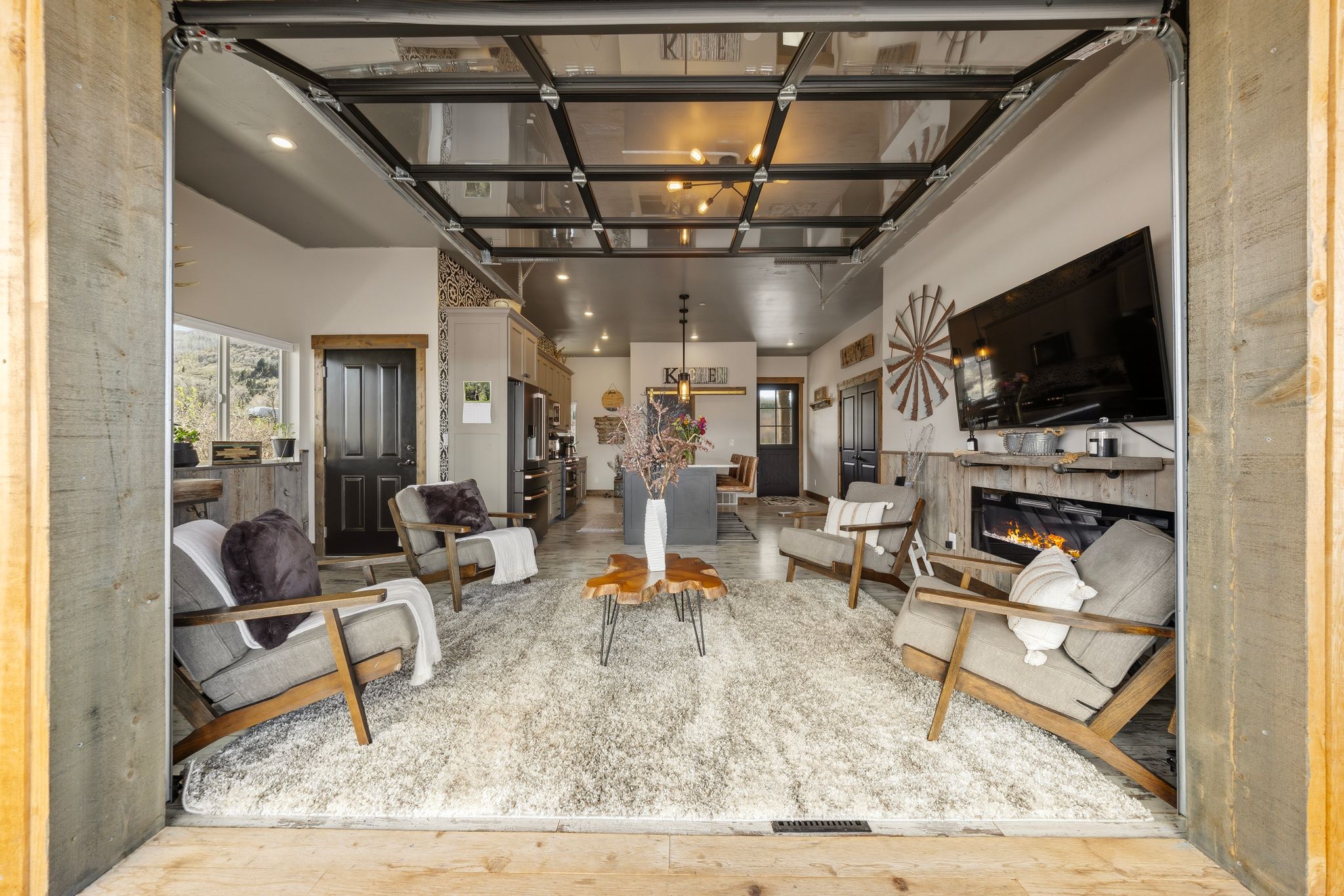 Living area with a glass covered fireplace and recessed lighting