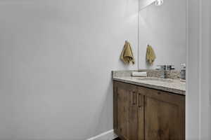 Bathroom featuring vanity and baseboards