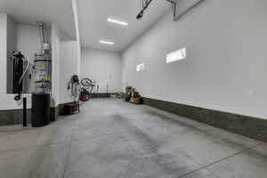 Garage with strapped water heater and electric vehicle charger