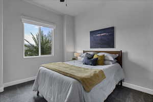 Bedroom featuring dark colored carpet and a ceiling fan