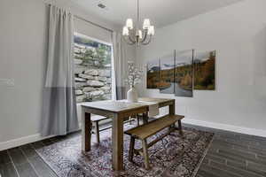 Dining area featuring wood tiled floors and suspended lighting