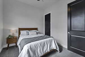 Bedroom featuring dark carpet and ceiling fan