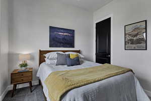 Bedroom featuring carpet floors and baseboards