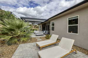 View of patio featuring an outdoor hangout area and a pergola