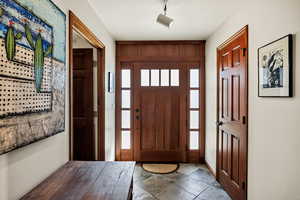 Foyer entrance featuring light stone finish floors