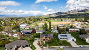 Aerial view of residential area featuring a mountainous background