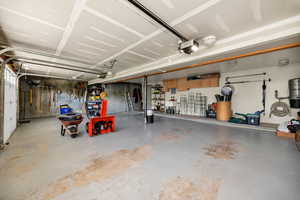Garage with a garage door opener and a central vacuum unit