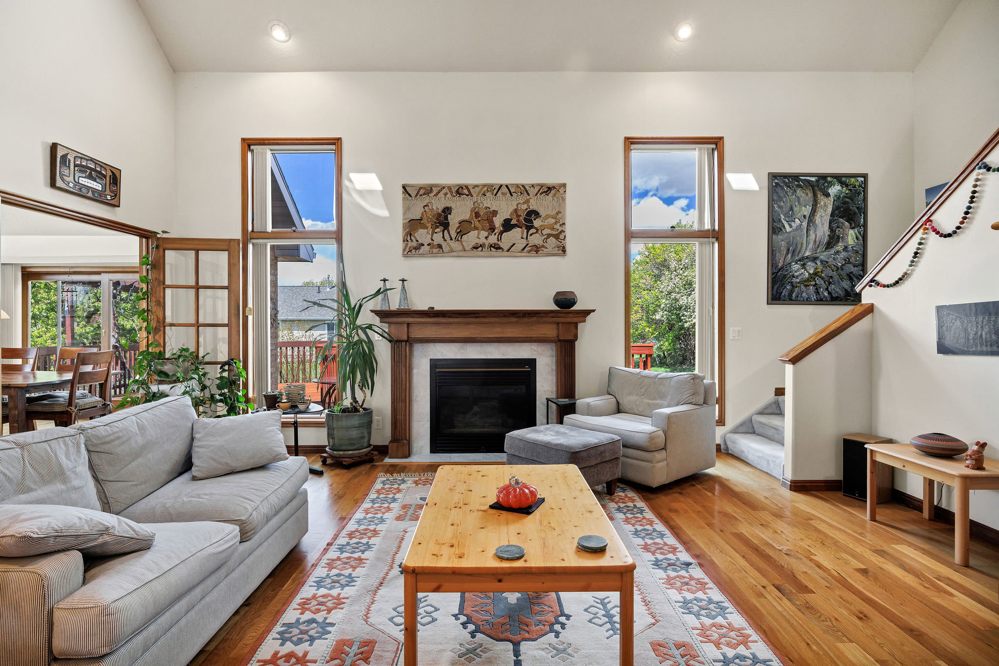 Living area featuring hardwood / wood-style flooring, a glass covered fireplace, recessed lighting, and healthy amount of natural light