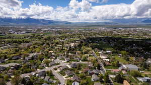 Aerial perspective of suburban area featuring a mountainous background