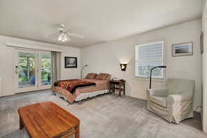 Main floor bedroom featuring Full bathroom and access to outside and ceiling fan