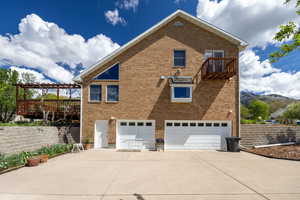 View of home's exterior featuring a garage, brick siding, a patio area, a pergola, and concrete driveway