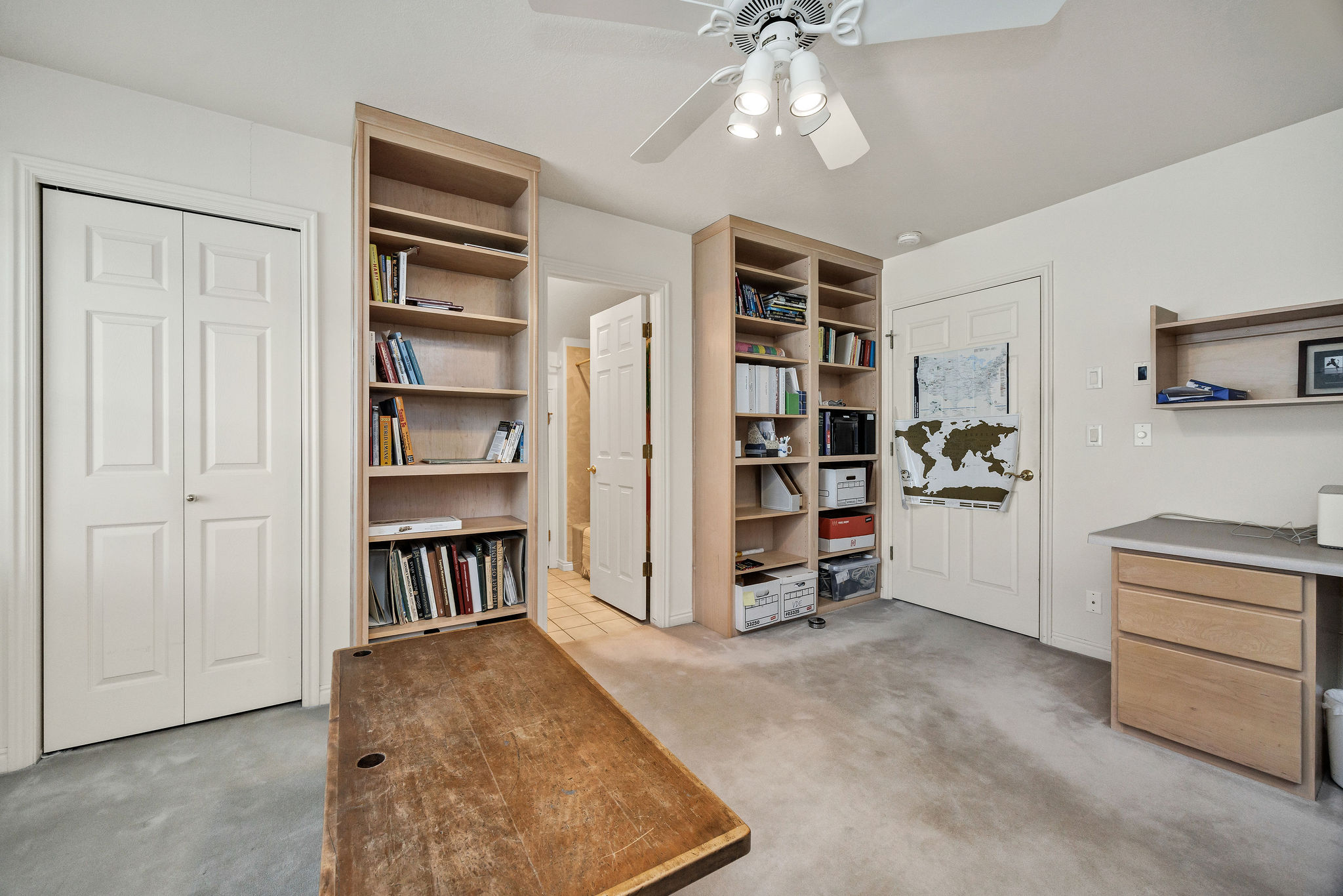 Office featuring a ceiling fan and light carpet