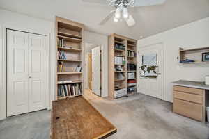 Office featuring a ceiling fan and light carpet