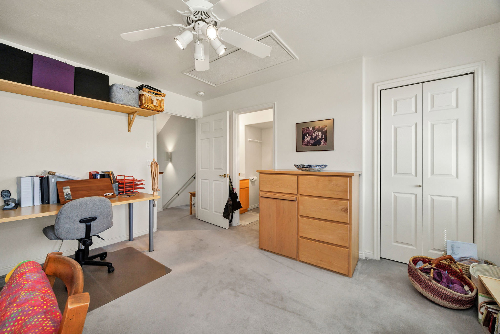 bedroom/Office with light colored carpet and a ceiling fan