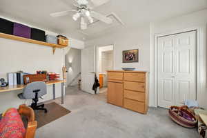 bedroom/Office with light colored carpet and a ceiling fan