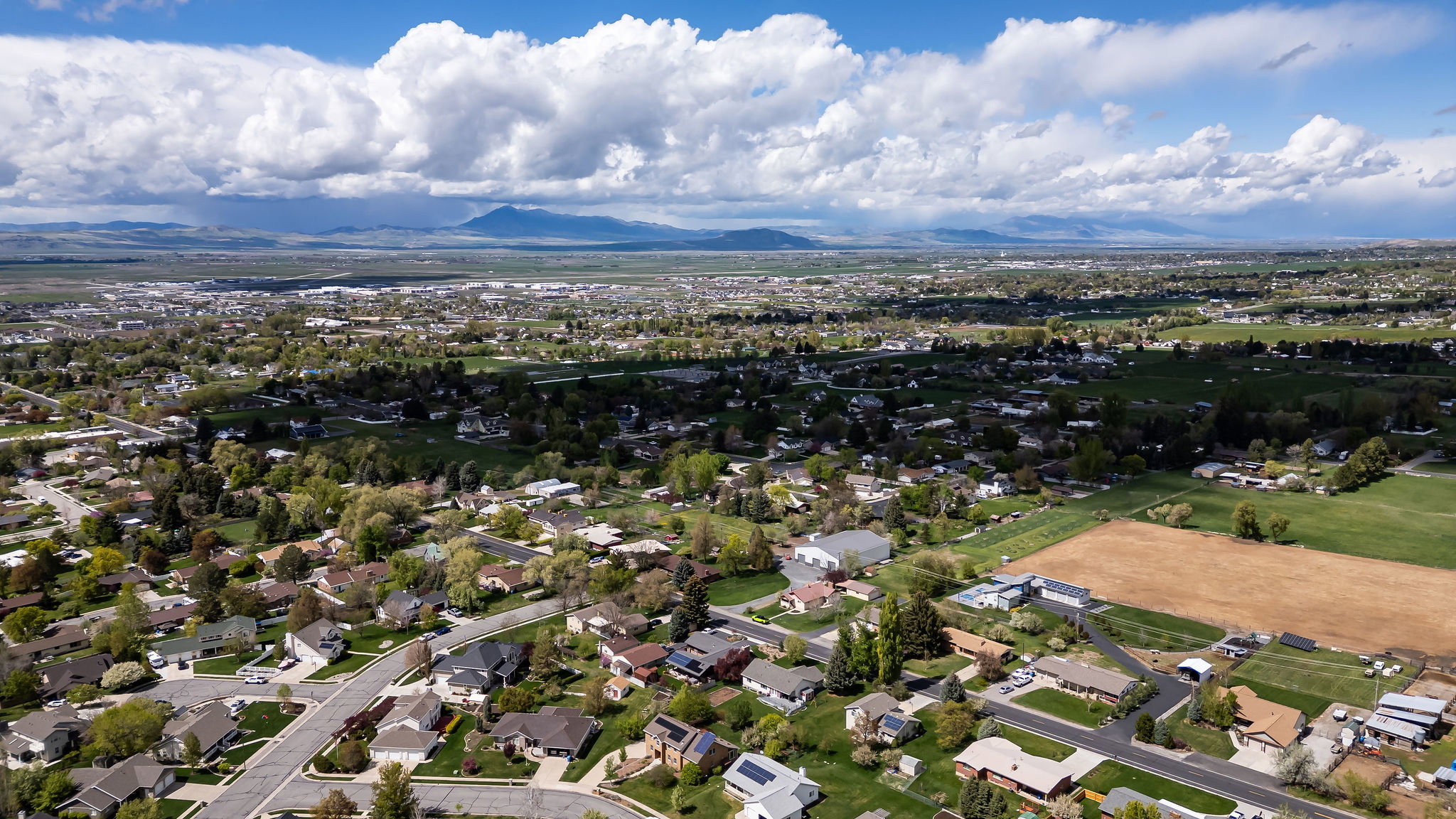 Aerial perspective of suburban area featuring a mountain backdrop