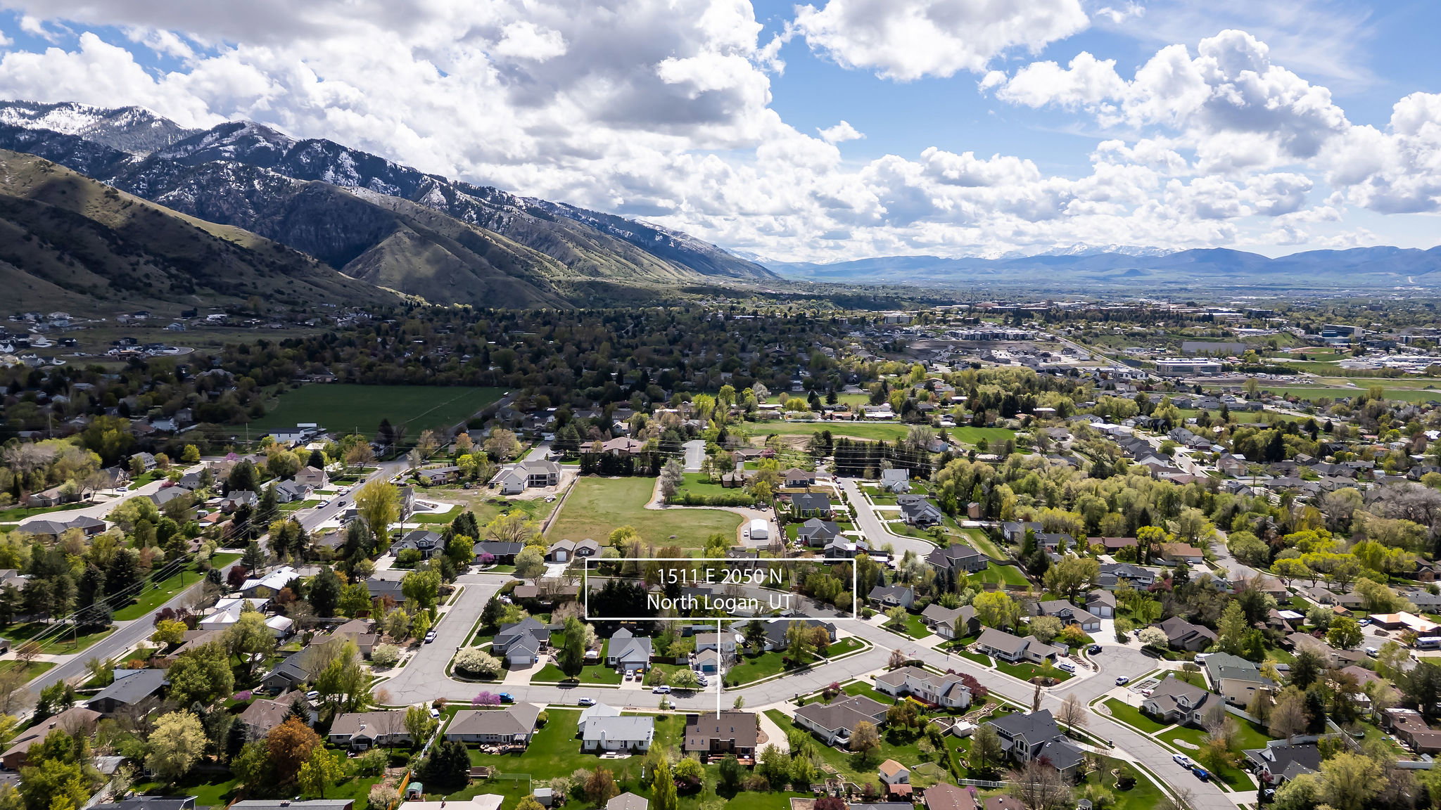 Aerial view of residential area featuring a mountainous background