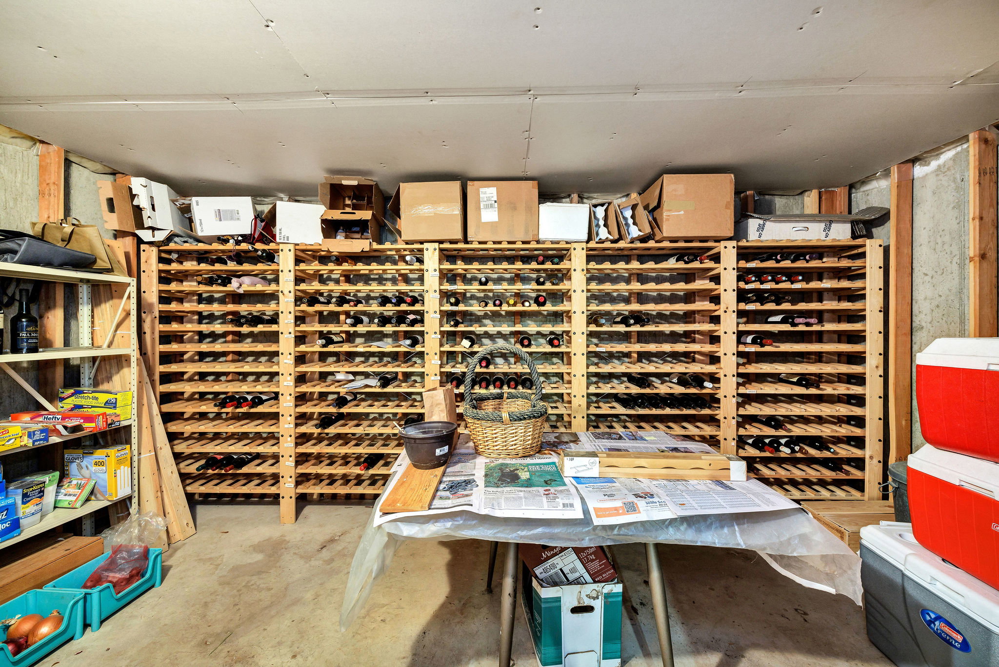 Wine cellar featuring unfinished concrete flooring