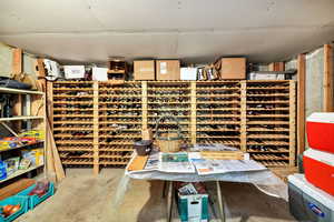 Wine cellar featuring unfinished concrete flooring