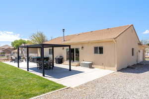 Rear view of house featuring a patio, stucco siding, a lawn, and a tile roof