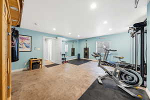 Workout area with recessed lighting and concrete floors