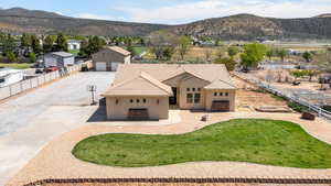 View of front of house with a mountain view and stucco siding