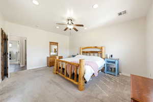 Bedroom featuring light carpet, ceiling fan, and recessed lighting