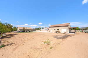 Back of house with a garage, a patio, and stucco siding