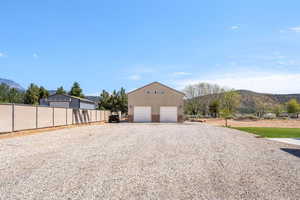 Garage with a mountain view, a garage, and driveway