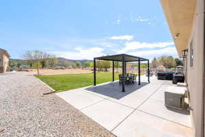 View of patio / terrace featuring a mountain view, a gazebo, and outdoor dining space