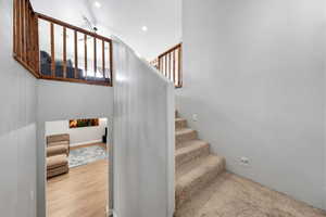 Staircase featuring recessed lighting and wood finished floors