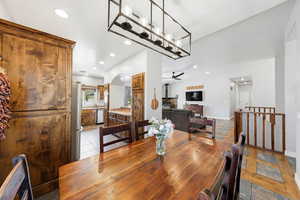 Dining room with arched walkways, recessed lighting, and light stone finish flooring