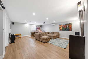 Living area featuring light wood-style floors and recessed lighting