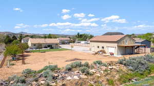 View of yard featuring a patio, a mountain view, and dirt driveway