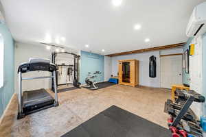 Workout area featuring a mini split for heating / cooling, a sauna, and recessed lighting