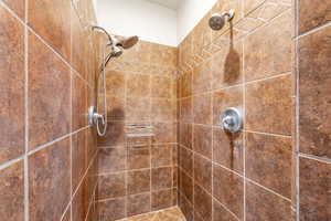 Full bath featuring a tile shower