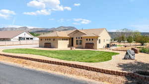 View of front of home featuring stucco siding and a mountain view