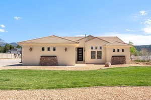 View of front of house with stucco siding, a mountain view, and a tiled roof