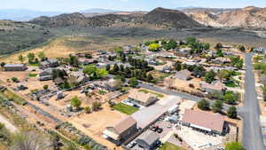 Aerial view of property's location with mountains and nearby suburban area