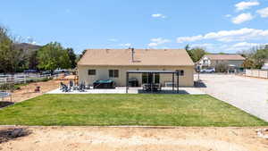 Back of house featuring a patio, stucco siding, and a tiled roof