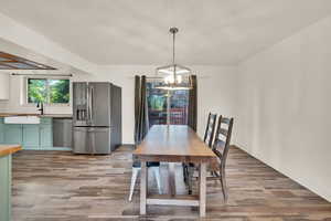 Dining space featuring light wood-style floors and a chandelier
