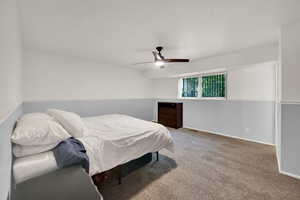 Bedroom with light carpet and a ceiling fan