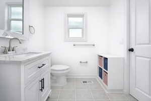 2nd en-suite bathroom with vanity and light tile patterned flooring