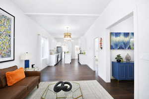 Living room featuring dark wood finished floors and a chandelier