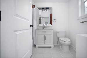 Second en-suite bath with vanity and light tile patterned floors. One of four total bathrooms. One of two en-suite bathrooms.