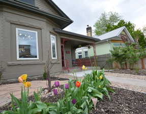 Doorway to property with brick siding and covered porch