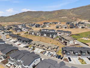 Aerial overview of property's location featuring mountains and nearby suburban area
